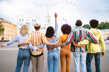 Multiracial young people together meeting and social gathering - Group of friends with mixed races having fun outdoors in the city- Friendship and lifestyle concepts - DMDF03481