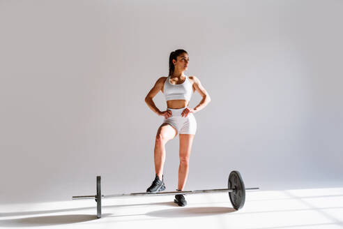 Young female athlete training in a gym using sport equipment. Fit woman working out . Concept about fitness, wellness and sport preparation. - DMDF03591