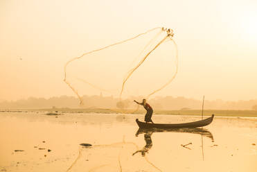 Fisherman at Inle Lake with traditional Intha conical net at