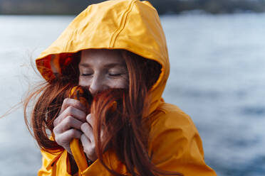 Redhead woman wearing yellow jacket - KNSF09774