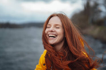 Redhead woman laughing and enjoying at lake - KNSF09778