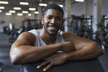 Lächelnder junger Mann im Fitnessstudio - KPEF00250