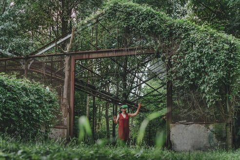 Woman with futuristic headset standing in greenhouse - YTF01101