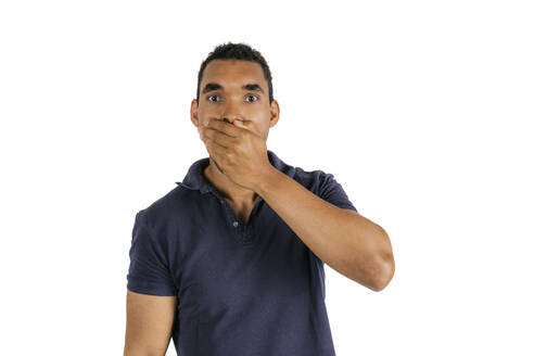Man covering mouth with hand against white background - PBTF00173