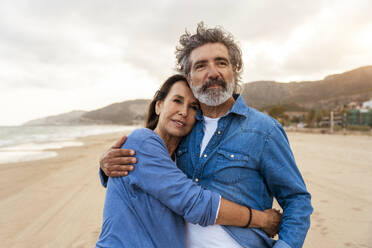 Senior woman embracing man standing at beach - OIPF03402