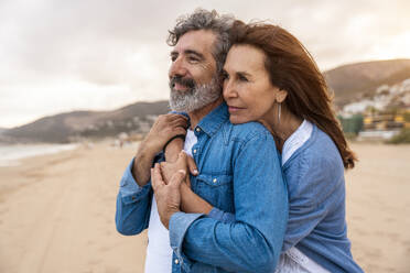 Senior woman embracing man at beach on weekend - OIPF03415