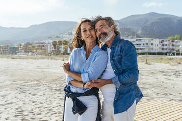 Thoughtful senior couple dancing together at beach - OIPF03459