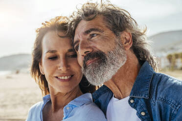 Contemplative senior man leaning on woman at beach - OIPF03465