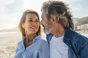 Smiling senior man and woman looking at each other on weekend - OIPF03467