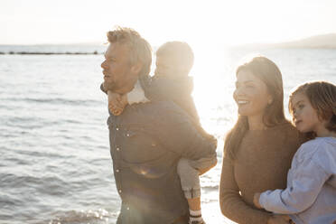 Happy family spending leisure time by sea at beach - JOSEF20610