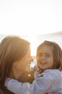 Happy mother and daughter at beach on holiday - JOSEF20636