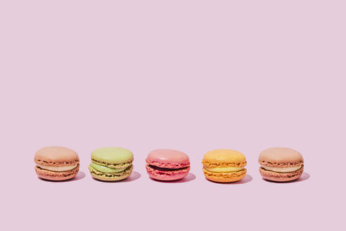 Colored macaroons on pink background - FLMF00996