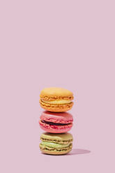Multi colored macaroons stacked in studio - FLMF00999