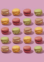 Multi colored macaroons arranged on pink background - FLMF01020