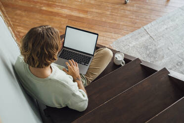 Junger Mann arbeitet zu Hause am Laptop - VPIF08493