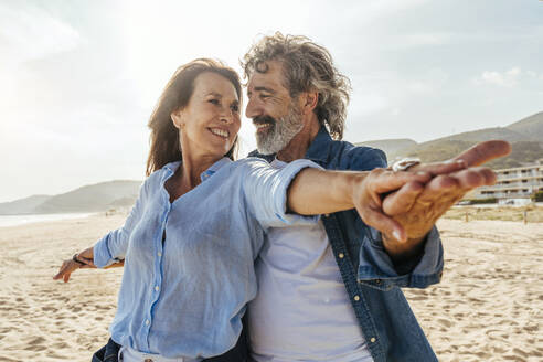 Happy couple enjoying vacations at beach on sunny day - OIPF03471