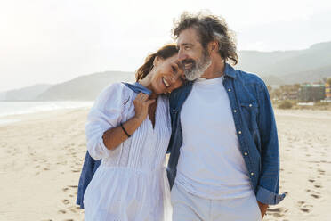 Cheerful woman embracing man at beach - OIPF03482