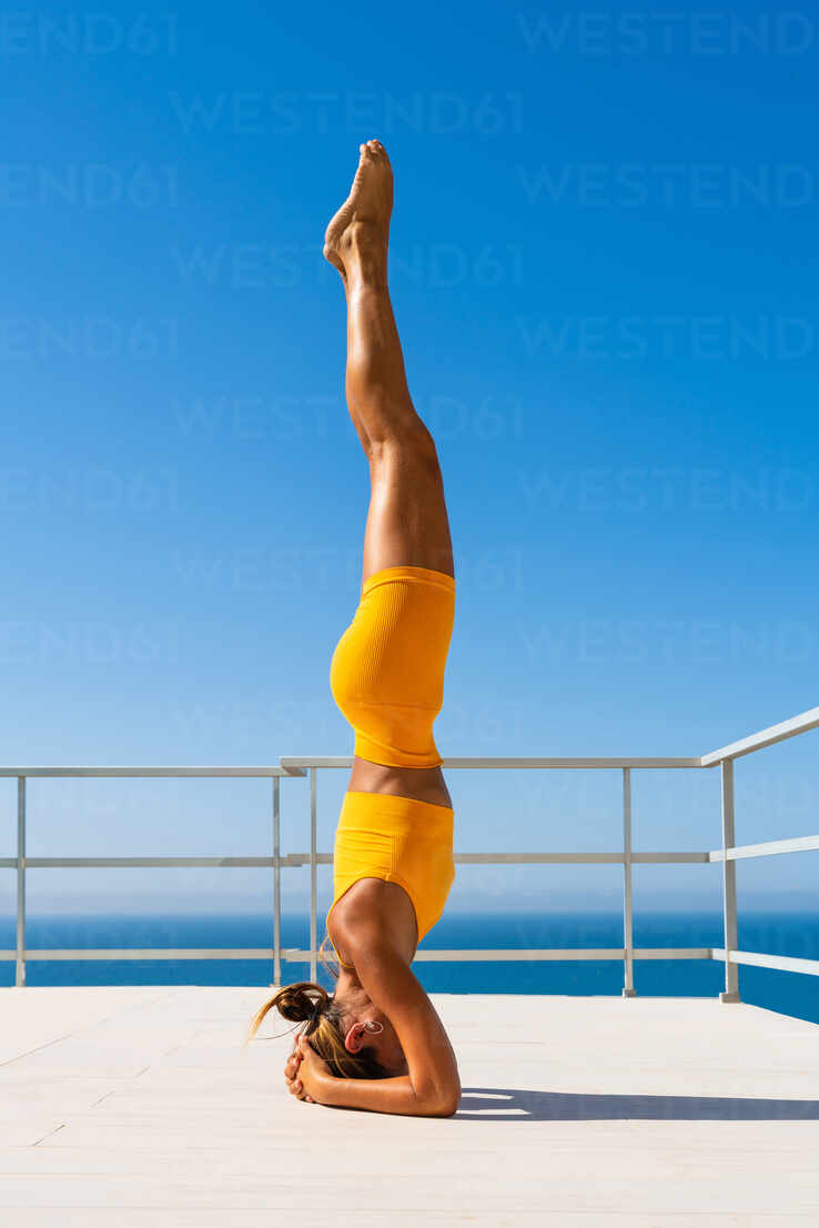 Beautiful young atlethic woman wearing sportswear doing yoga
