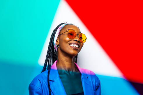 Beautiful afro-american woman with afro pigtails hairstyle and stylish clothes - Portrait of young black girl in studio - DMDF03806