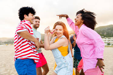 Multiethnic group of young happy friends bonding outside, having fun on summertime vacation - Multicultural cheerful people with summer clothes enjoying summer holidays, concepts about youth, friendship and positive emotion - DMDF03967