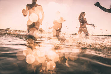 Group of friends having fun at the sea - Happy young people on a summer vacation at the beach - DMDF03999