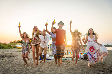 Happy group of friends celebrating and having fun on the beach - Young people on summer holiday - DMDF04045