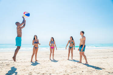 Group of friends having fun on the beach - Young and happy tourists bonding outdoors, enjoying summertime - DMDF04111