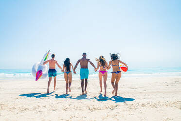 Group of friends having fun on the beach - Young and happy tourists bonding outdoors, enjoying summertime - DMDF04122