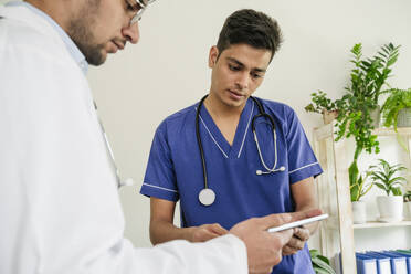 Two doctors using tablet PC together in clinic - OSF02077