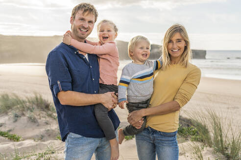 Happy family enjoying together at beach - SBOF04006