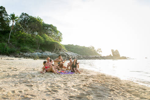 Group of happy friends on a tropical island having fun - Young adults playing together on the beach, summer vacation on a beautiful beach - DMDF04143