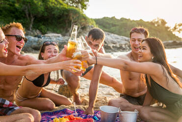 Group of happy friends on a tropical island having fun - Young adults playing together on the beach, summer vacation on a beautiful beach - DMDF04150