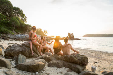 Group of happy friends on a tropical island having fun - Young adults playing together on the beach, summer vacation on a beautiful beach - DMDF04167