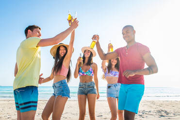 Group of friends having fun on the beach - Young and happy tourists bonding outdoors, enjoying summertime - DMDF04181