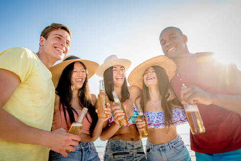 Group of friends having fun on the beach - Young and happy tourists bonding outdoors, enjoying summertime - DMDF04184