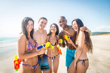 Group of friends having fun on the beach - Young and happy tourists bonding outdoors, enjoying summertime - DMDF04191