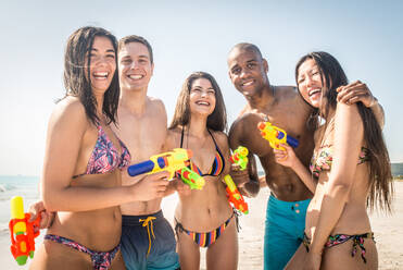 Group of friends having fun on the beach - Young and happy tourists bonding outdoors, enjoying summertime - DMDF04192