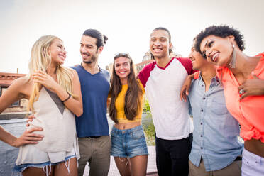 Young happy people having a barbecue dinner on a rooftop in New York - Group of friends having party and having fun - DMDF04274