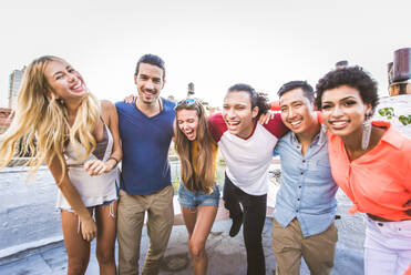 Young happy people having a barbecue dinner on a rooftop in New York - Group of friends having party and having fun - DMDF04275