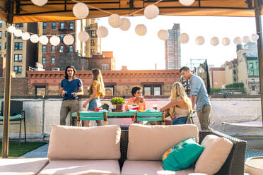 Young happy people having a barbecue dinner on a rooftop in New York - Group of friends having party and having fun - DMDF04303