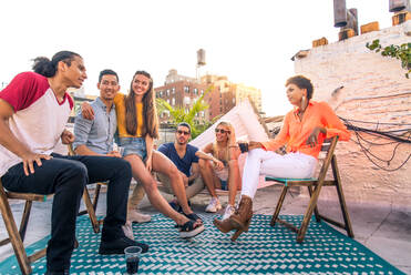 Young happy people having a barbecue dinner on a rooftop in New York - Group of friends having party and having fun - DMDF04318