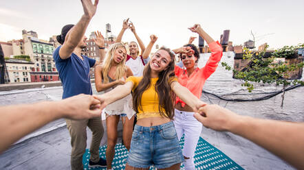 Young happy people having a barbecue dinner on a rooftop in New York - Group of friends having party and having fun - DMDF04333