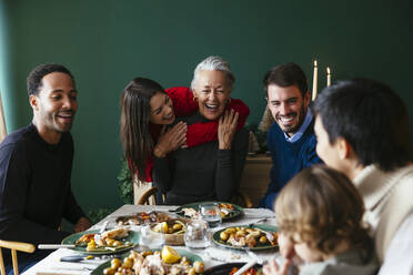 Multiracial family enjoying dinner party on Christmas vacation - EBSF03793