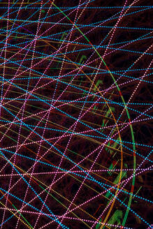 Germany, Bavaria, Wurzburg, Multiple exposure of spinning Ferris wheel at night - NDF01576