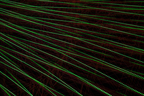 Germany, Bavaria, Wurzburg, Multiple exposure of spinning Ferris wheel at night - NDF01577