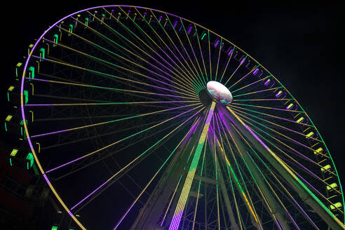 Germany, Bavaria, Wurzburg, Multiple exposure of spinning Ferris wheel at night - NDF01584