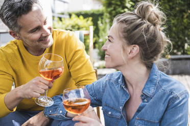 Portrait of couple enjoying drink outdoors - UUF30173