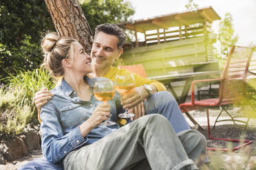 Portrait of couple enjoying drink outdoors - UUF30177