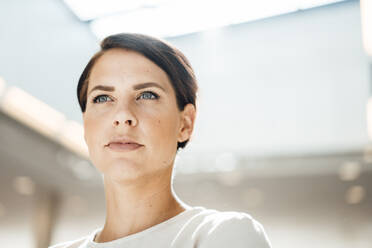 Confident businesswoman with short hair and gray eyes at office - JOSEF20748