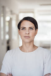 Contemplative businesswoman with short hair in office - JOSEF20810